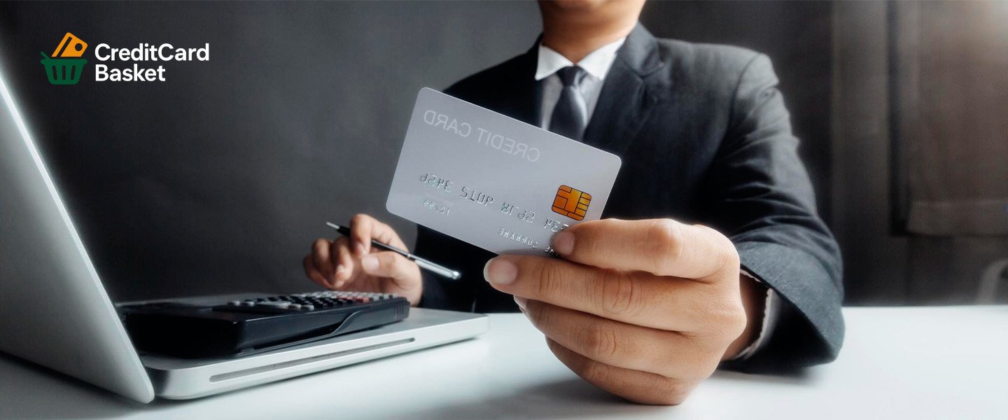 ( First-Time Credit Card for Beginners )- A businessman confidently managing his finances on a computer while holding his best first-time credit card, symbolizing smart credit habits in 2026.